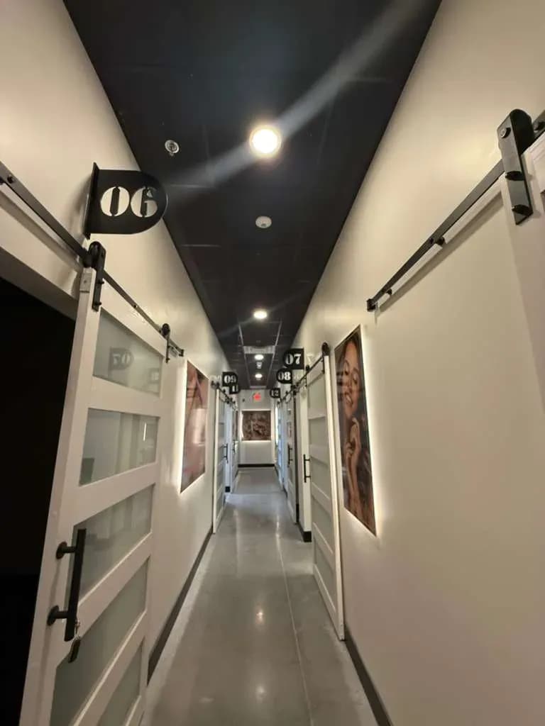 The suite corridor at MNA, numbered doors on both sides