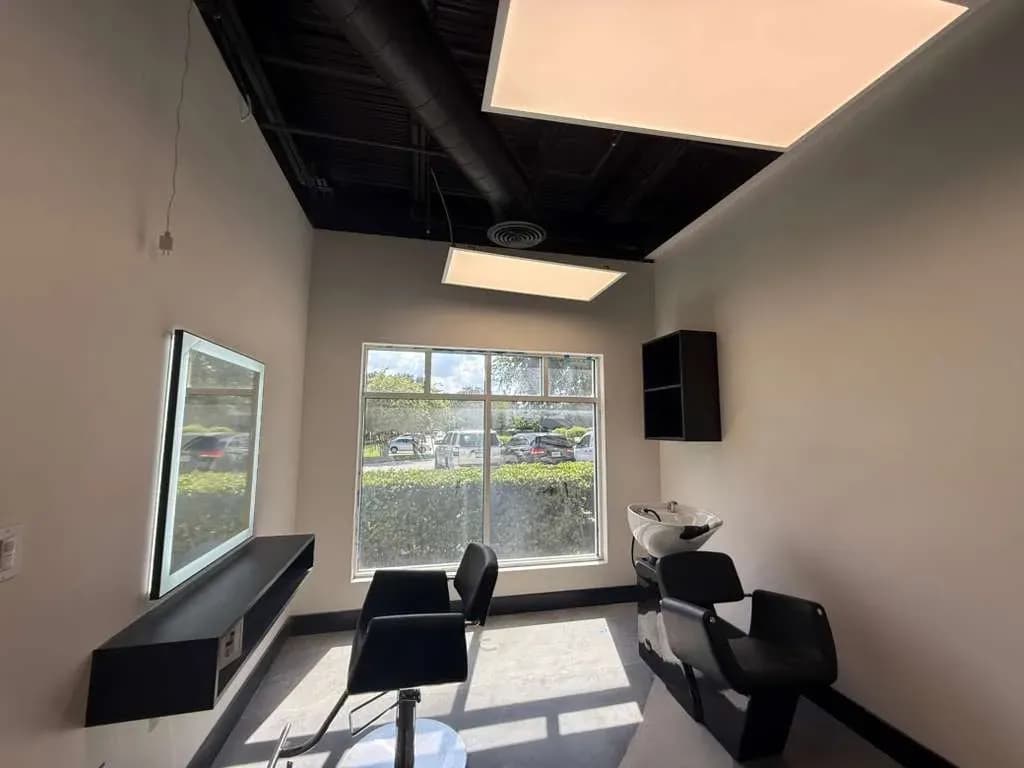 A single suite at MNA Salon Suites with a large window and daylight